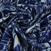 Fluweel stretch – White palm leaves on blue crushed look