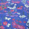 Stretch katoen – Poppy on blue denim