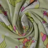Sweaterstof / Jogging alpenfleece – Eenhoorn cupcakes licht limegroen